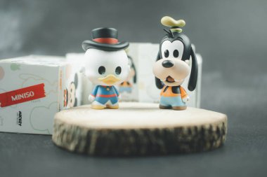 Samut Prakan, Thailand - May 22, 2021 : Cute figurine Goofy and Scrooge McDuck (Mickey Mouse Family Figure Blind Box Collection) new collections from Miniso shop