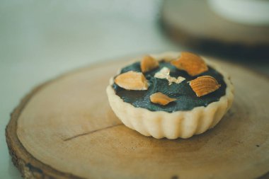Chocolate tarts with almond on a wooden board. Close up