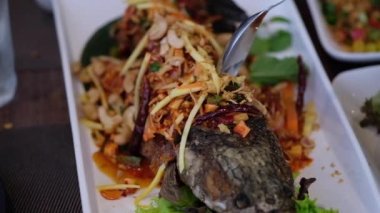 Kızarmış balık, salata soslu yılan kafa. Tayland Yemeği 