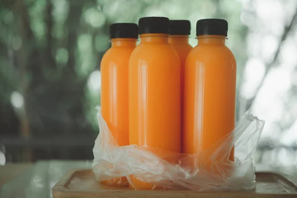 Many orange juice bottles in plastic bag. The concept of delivery drink