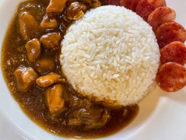 Stew pork served with chinese sausage sliced eating with rice. Top view