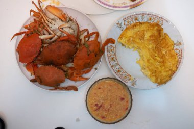 Haşlanmış yengeç ve baharatlı deniz ürünleri soslu Tayland omleti. Ev yapımı yemek kavramı.