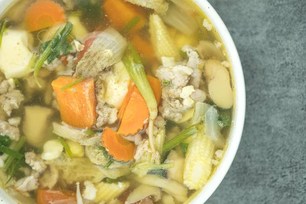 Clear soup with minced pork and mix vegetables in white bowl, Thai homemade food. Thai called Gaeng-Jued