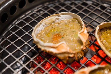 Kani miso Crab carapace grilled on charcoal stove. Selective focus