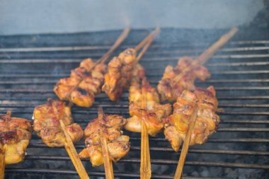 Tütsülenmiş mangal kömürü üzerine ızgara tavuk.