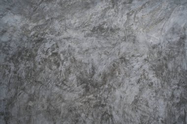 Soyut gri çimento arka planda cilalanmış beton dokusu var. Modern tasarım, duvar kağıdı veya ürün arkaplanı için pürüzlü, benekli desenli sanayi tipi duvar yüzeyi.
