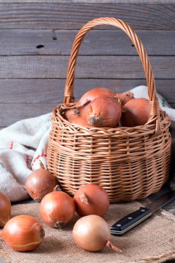 Bir tabloda, dikey sepet içinde çiğ soğan