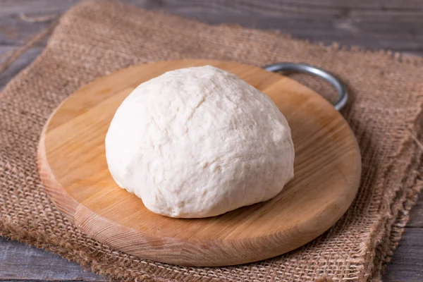 Ball of dough on a cutting board — Stock Photo, Image