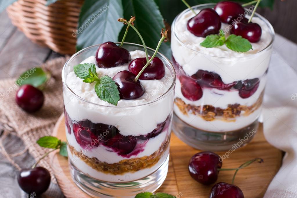 Milk dessert with ripe cherries in a glass jar Stock Photo by ©qwartm 115559708