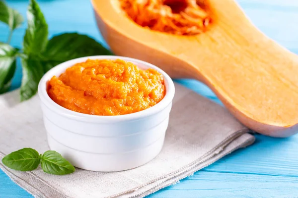 Organic pumpkin puree on a blue wooden table. Selective focus — Stock Image Organic Pumpkin Puree Blue Wooden Table Selective Focus Stock Image