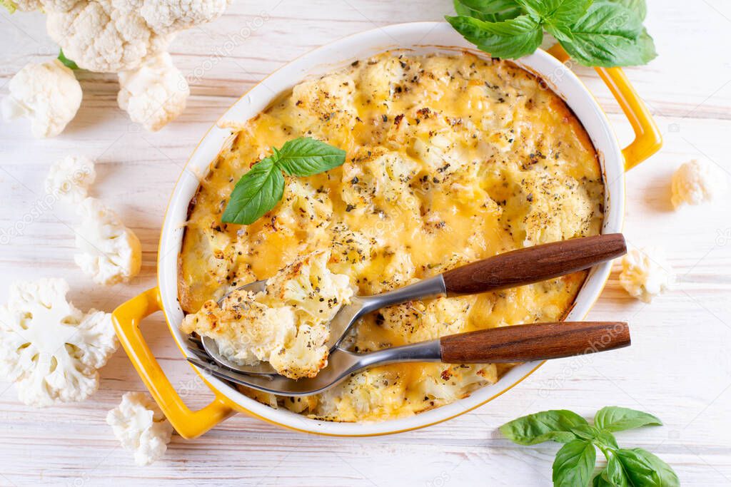 Casserole with cauliflower, eggs and cheese in a ceramic pot. Top view