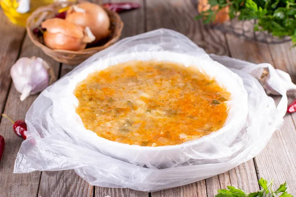 Frozen soup in a bowl on a wooden background. Frozen food, healthy food — Stock Image Frozen Soup Bowl Wooden Background Frozen Food Healthy Food Royalty Free Stock Images