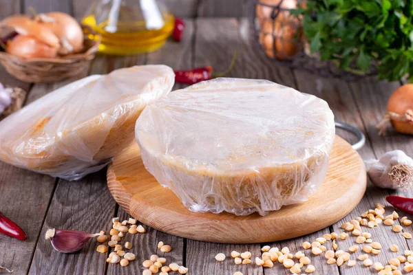 Frozen soup in a plastic bag on a wooden background. Frozen food, healthy food — Stock Image Frozen Soup Plastic Bag Wooden Background Frozen Food Healthy Food Royalty Free Stock Images