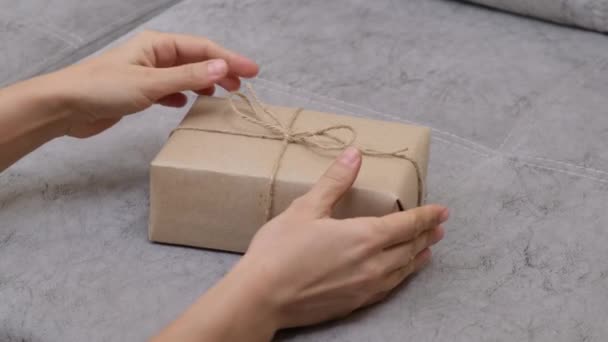 Hands Woman Unwraps Gift Removing Jute Rope Gift Box Gifts — Stok video