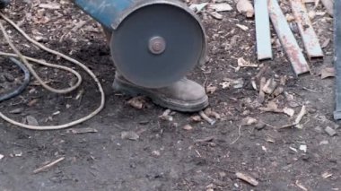 Man works circular saw. Sparks fly from hot metal