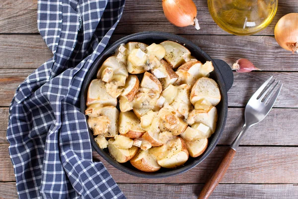 Baked potato wedges with cheese and herbs wooden table - homemade organic vegetable, vegetarian potato wedges, snack food meal