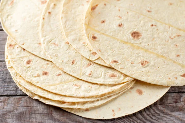 Grilled tortillas, flat breads on a wooden table