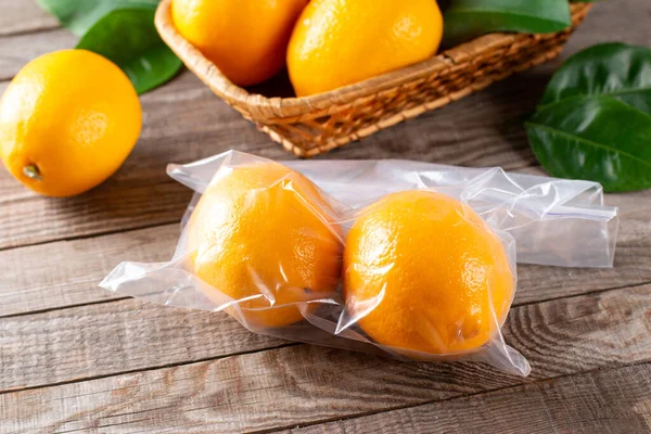 Fresh ripe lemons in a freezer bag on a table
