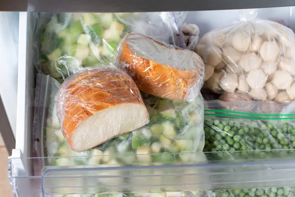 Frozen bread in the home freezer. The frozen products. Long life food storage concept.