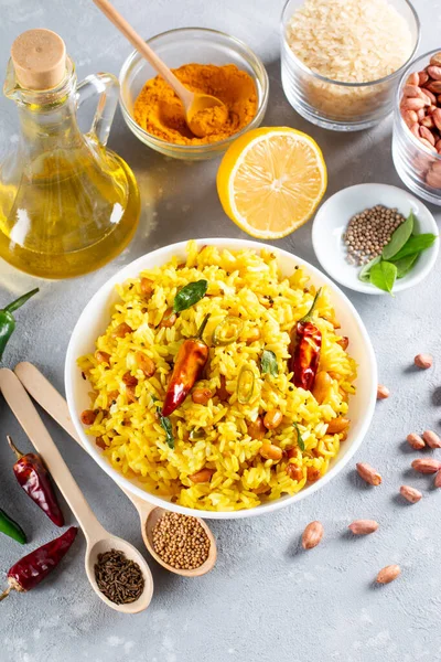 Lemon rice with curry leaf and with green chili, served in a bowl, selective focus