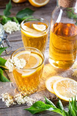 Ahşap masadaki mürver çiçeğinin organik içecek suyu.