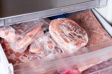 Raw frozen meat. Raw pork chops in the freezer. Frozen food clipart