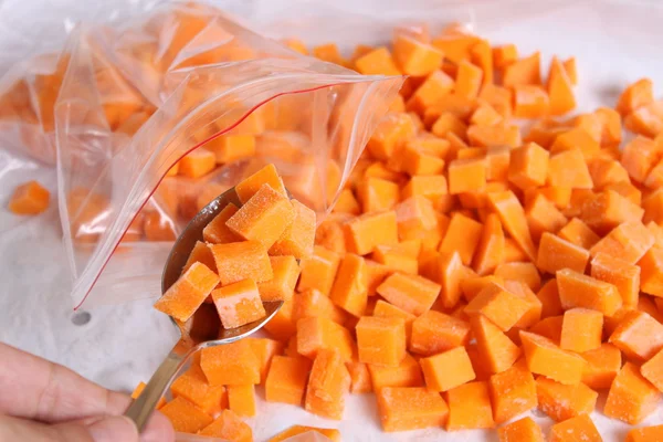 Raw pumpkin cubes in a spoon — Stock Photo, Image