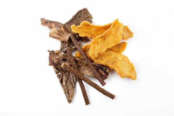 a mix of dog treats, dried chicken tenders, dried beef tendon, and formed beef sticks on white background