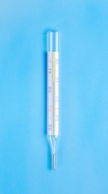 Mavi arka planda yüksek sıcaklık değerleri olan termometre. Viral enfeksiyon, zatürree.