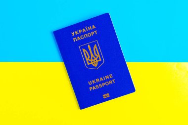Ukrayna bayrağının arka planına karşı uluslararası pasaport. Sınırı geçmek için belge.