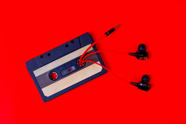 Old Audio Cassette Wired Vacuum Headphones Red Background — Stock Photo, Image