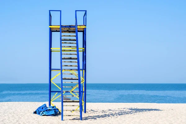 A lifeguard tower on a deserted sea beach. Rescue people in a difficult situation. Watching the rest in the water.