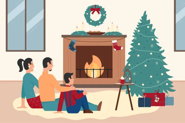 Happy family people sitting by xmas fireplace at home