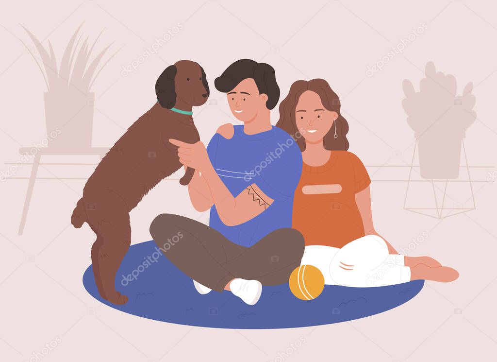 Man and woman couple spend time and playing with pet at home together