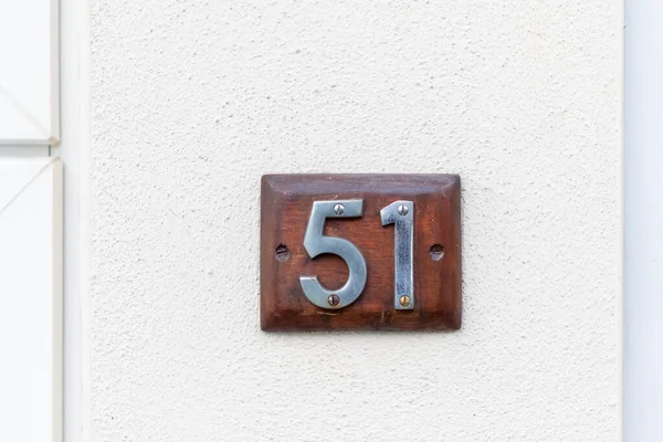 Una Placa Madera Una Pared Blanca — Foto de Stock