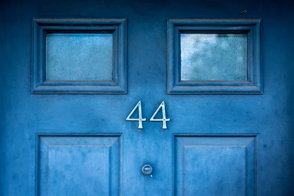 House door number 44 on a dark blue door