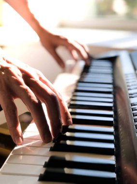 Piyanist el dijital piyano çalıyor. Yakın plan. Müzik konsepti, piyano çalmayı öğrenmek. Mesaj için yer var. Sesli