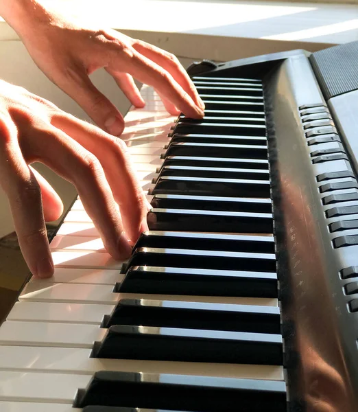 Pianist hand playing digital piano. Close-up. Music concept, learning to play the piano. Space for text. Vectical