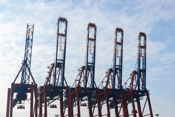Container terminal gantry cranes for loading and offloading intermodal containers from container cargo ships in Hamburg Germany