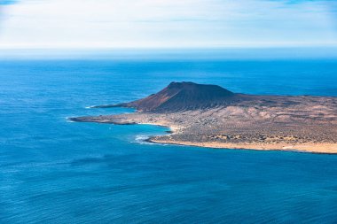 Volkanik ada La Graciosa 'nın Atlantik Okyanusu' ndaki, Mirador del Rio, Lanzarote, Kanarya Adaları 'ndaki volkanik koninin benzersiz panoramik görüntüsü. Seyahat kavramı.