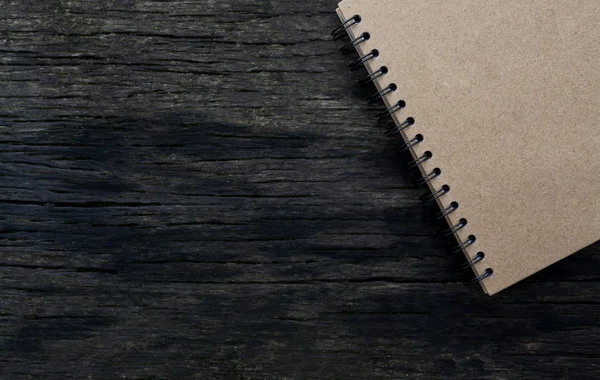 Brown notebook on wood background — Stock Photo, Image