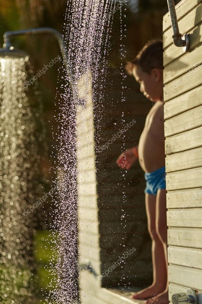 Cute little boy taking shower on the beach — Stock Photo © mochak