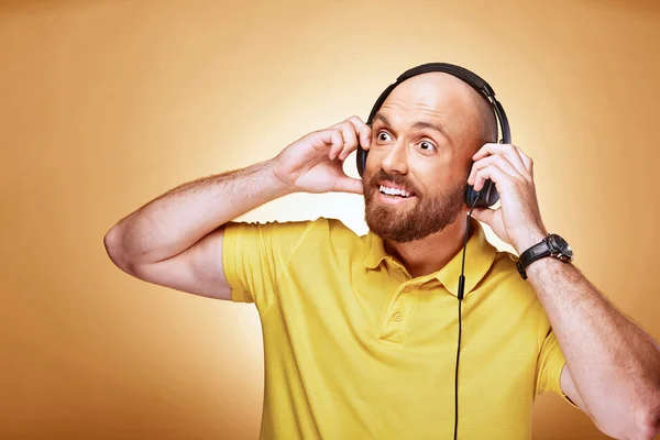 Retrato de homem careca barbudo feliz com fones de ouvido e relógio — Fotografia de Stock