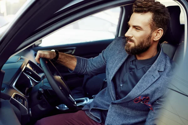 Handsome elegant man in a car — Stock Photo, Image