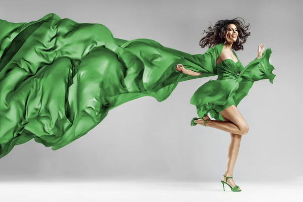 Woman in waving dress with flying fabric — Stock Photo, Image