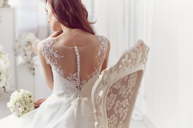 The beautiful woman posing in a wedding dress