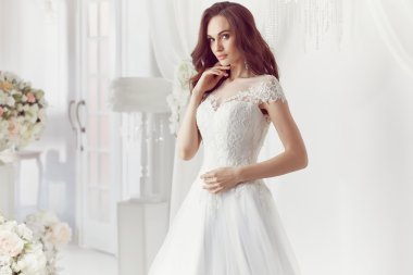 The beautiful woman posing in a wedding dress