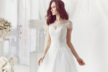The beautiful woman posing in a wedding dress