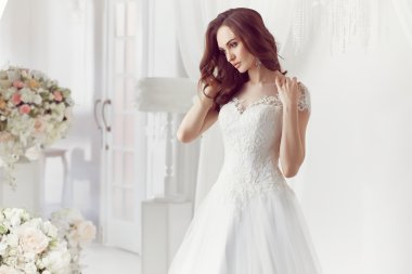 The beautiful woman posing in a wedding dress