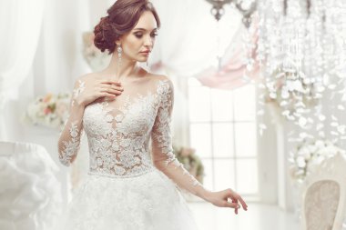 The beautiful woman posing in a wedding dress